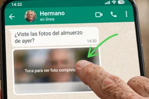 Dedo tocando una foto pequeña en WhatsApp para abrirla